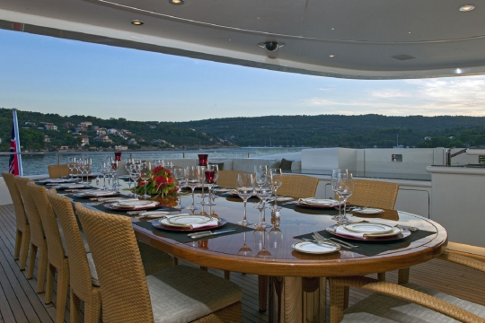 Motor Yacht Mary-Jean II Isa for charter - bridge deck dining table aft