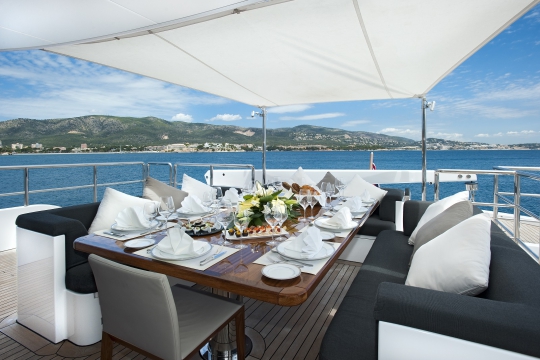 Motor Yacht Christina G Kingship for charter - bridge deck exterior dining table